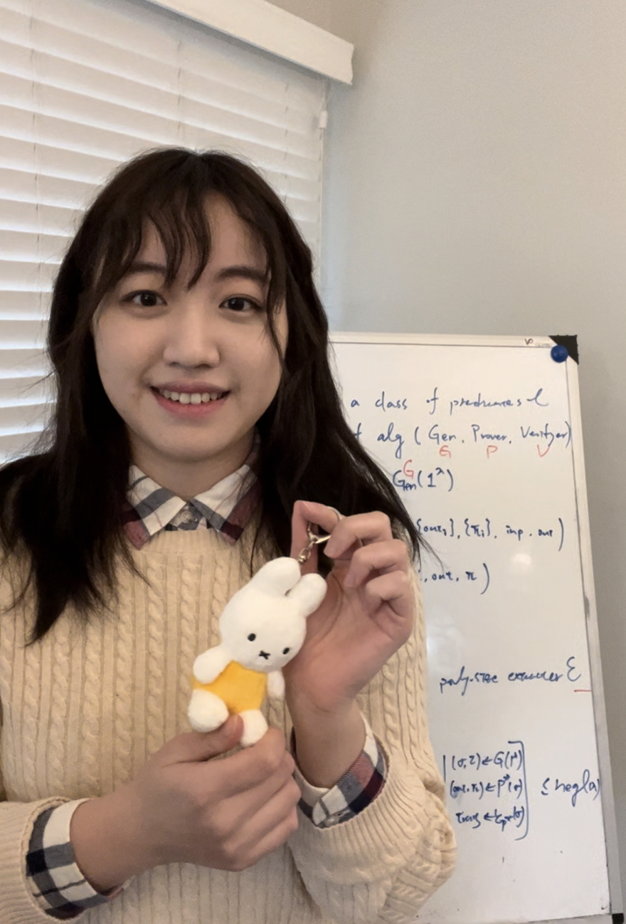 Miryam Huang holding a small Miffy figure in front of a whiteboard